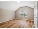 Cozy bedroom with vaulted ceiling, wood floors, and natural light at 231 Chestnut Ridge St, Winter Springs, FL 32708