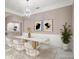 Dining area with a marble table, modern chairs, and stylish light fixture at 231 Chestnut Ridge St, Winter Springs, FL 32708