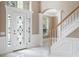 Elegant foyer with beautiful stained glass front door, staircase and marble floors, creating a welcoming space at 231 Chestnut Ridge St, Winter Springs, FL 32708