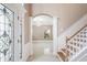 Inviting foyer featuring decorative glass door, marble floors, and elegant staircase at 231 Chestnut Ridge St, Winter Springs, FL 32708
