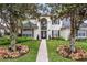Charming two-story home with a brick pathway, lush lawn, and a large window above the front door at 231 Chestnut Ridge St, Winter Springs, FL 32708