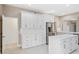 Modern kitchen showcasing white cabinetry, stainless steel appliances, and a large island with ample counter space at 231 Chestnut Ridge St, Winter Springs, FL 32708