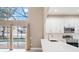 Bright modern kitchen featuring white cabinetry, stainless steel appliances, and access to the outdoor pool area at 231 Chestnut Ridge St, Winter Springs, FL 32708