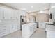 Spacious kitchen with an island, stainless steel appliances, ample white cabinetry, and modern design elements at 231 Chestnut Ridge St, Winter Springs, FL 32708