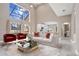 Open-concept living room with comfortable seating and view to the kitchen at 231 Chestnut Ridge St, Winter Springs, FL 32708