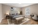 Virtually staged main bedroom showcases a cozy setting with neutral tones and soft decor at 231 Chestnut Ridge St, Winter Springs, FL 32708