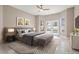 Stylishly staged main bedroom with a large bed, neutral decor, and access to the pool area at 231 Chestnut Ridge St, Winter Springs, FL 32708