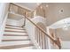 Classic staircase with white spindles and wooden handrail leading to the second floor at 231 Chestnut Ridge St, Winter Springs, FL 32708