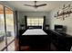 Light-filled bedroom with hardwood floors, ceiling fan, dark furniture, and a sliding glass door to the outside at 2328 Midtown Ter # 1024, Orlando, FL 32839
