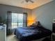 Comfortable bedroom features a large window with privacy blinds and neutral walls at 2328 Midtown Ter # 1024, Orlando, FL 32839