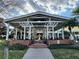 Exterior shot of the outdoor clubhouse area with white pergola, plants and a fountain at 2328 Midtown Ter # 1024, Orlando, FL 32839