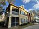 Beautiful yellow two-story apartment building with screened-in porch and balcony, near water at 2328 Midtown Ter # 1024, Orlando, FL 32839