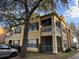 Charming yellow two-story home with a screened-in porch and balcony offering a cozy outdoor space at 2328 Midtown Ter # 1024, Orlando, FL 32839