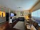 Hardwood floors, neutral paint, large window, and comfortable seating define this cozy living space at 2328 Midtown Ter # 1024, Orlando, FL 32839