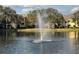 A serene pond featuring a central fountain, surrounded by residential buildings at 2328 Midtown Ter # 1024, Orlando, FL 32839