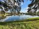 Scenic view of a tranquil pond with a fountain, surrounded by lush green grass and trees at 2328 Midtown Ter # 1024, Orlando, FL 32839