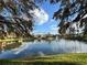 Picturesque view of the lake reflecting nearby buildings, landscaping and fountain at 2328 Midtown Ter # 1024, Orlando, FL 32839
