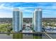 Stunning aerial view of twin high-rise towers with waterfront pool and picturesque landscaping at 241 Riverside Dr # 201, Daytona Beach, FL 32117