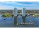 Stunning aerial view showcasing waterfront towers, a marina, and lush surroundings at 241 Riverside Dr # 201, Daytona Beach, FL 32117