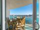 Cozy balcony with dining set overlooking the water, perfect for enjoying outdoor meals and scenic views at 241 Riverside Dr # 201, Daytona Beach, FL 32117