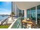 Balcony with outdoor seating, a view of the water, pool, and a nearby building at 241 Riverside Dr # 201, Daytona Beach, FL 32117