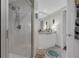 Bathroom featuring a walk-in shower, sleek vanity, and neutral tile flooring at 241 Riverside Dr # 201, Daytona Beach, FL 32117