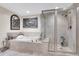 This bathroom features a seamless glass shower adjacent to the bathtub and decorative art pieces at 241 Riverside Dr # 201, Daytona Beach, FL 32117