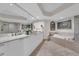 Spacious bathroom offers a soaking tub, seamless shower, and ample counter space with modern fixtures at 241 Riverside Dr # 201, Daytona Beach, FL 32117