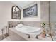 Relaxing bathtub featuring marble surround, and decorative art pieces to create a luxurious spa-like experience at 241 Riverside Dr # 201, Daytona Beach, FL 32117