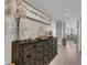 Hallway with wood floors, dark wood credenza, and decorative items with a peek into the living room at 241 Riverside Dr # 201, Daytona Beach, FL 32117