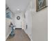Neutral toned hallway with wood floors, front door with wreath, and artwork on the walls at 241 Riverside Dr # 201, Daytona Beach, FL 32117