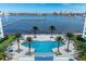 Overhead of a geometric community pool with seating and palm trees with the bay in the background at 241 Riverside Dr # 201, Daytona Beach, FL 32117