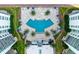 Aerial view of the luxurious pool area with palm trees and lounge chairs at 241 Riverside Dr # 201, Daytona Beach, FL 32117