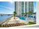Exterior view of waterfront pool with lounge seating and bridge views at 241 Riverside Dr # 201, Daytona Beach, FL 32117