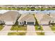 Aerial view of a single Gathering home with a well-manicured front yard and a two-car garage at 2496 Pine Preserve Ct, St Cloud, FL 34771