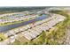 An aerial view showcasing a waterfront community with beautiful landscaping at 2496 Pine Preserve Ct, St Cloud, FL 34771