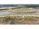 This aerial view displays the property backed by a beautiful pond at 2496 Pine Preserve Ct, St Cloud, FL 34771