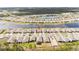 Aerial view of a community with houses near a lake, location marked with a red pin at 2496 Pine Preserve Ct, St Cloud, FL 34771