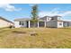 Expansive backyard featuring a screened lanai perfect for outdoor relaxation and entertainment at 2496 Pine Preserve Ct, St Cloud, FL 34771