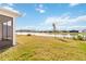 A luscious green backyard with a picturesque lake view and beautiful sky at 2496 Pine Preserve Ct, St Cloud, FL 34771