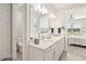 Bright bathroom boasts double sinks, modern fixtures and a doorway to bedroom at 2496 Pine Preserve Ct, St Cloud, FL 34771