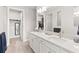 Spacious bathroom with double sinks, large mirrors, and a walk-in closet at 2496 Pine Preserve Ct, St Cloud, FL 34771