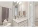 Bright bathroom featuring a modern vanity, sleek fixtures and a framed mirror at 2496 Pine Preserve Ct, St Cloud, FL 34771
