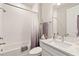 Bathroom with a shower-tub combo, soft towels, and a sink with marble countertop at 2496 Pine Preserve Ct, St Cloud, FL 34771