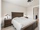 Bedroom with a comfortable bed, stylish lamps, and wood look flooring at 2496 Pine Preserve Ct, St Cloud, FL 34771