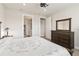 Comfortable bedroom showing a dresser, bed, and an ensuite bathroom at 2496 Pine Preserve Ct, St Cloud, FL 34771