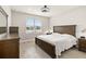 Cozy bedroom with wood furniture, bright window, and wood look flooring at 2496 Pine Preserve Ct, St Cloud, FL 34771