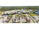 Aerial view of the community's clubhouse with a pool, parking, and luxurious amenities at 2496 Pine Preserve Ct, St Cloud, FL 34771