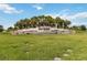Community entrance sign surrounded by swaying palm trees on a vibrant sunny day at 2496 Pine Preserve Ct, St Cloud, FL 34771