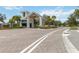 Grand entrance to the community featuring a gated entry and lush landscaping at 2496 Pine Preserve Ct, St Cloud, FL 34771